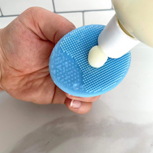 Load image into Gallery viewer, honey face wash being put on a silicone brush to show texture of the product